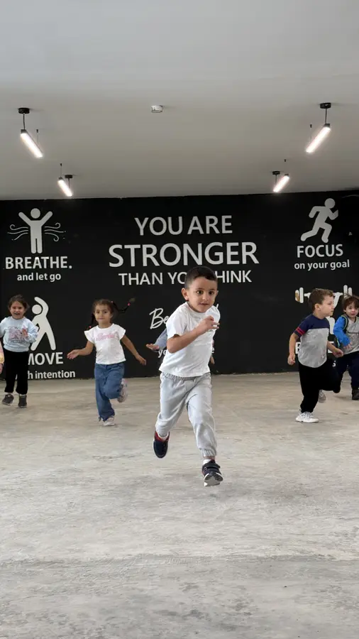 Students running in the sports hall at Inspire International School